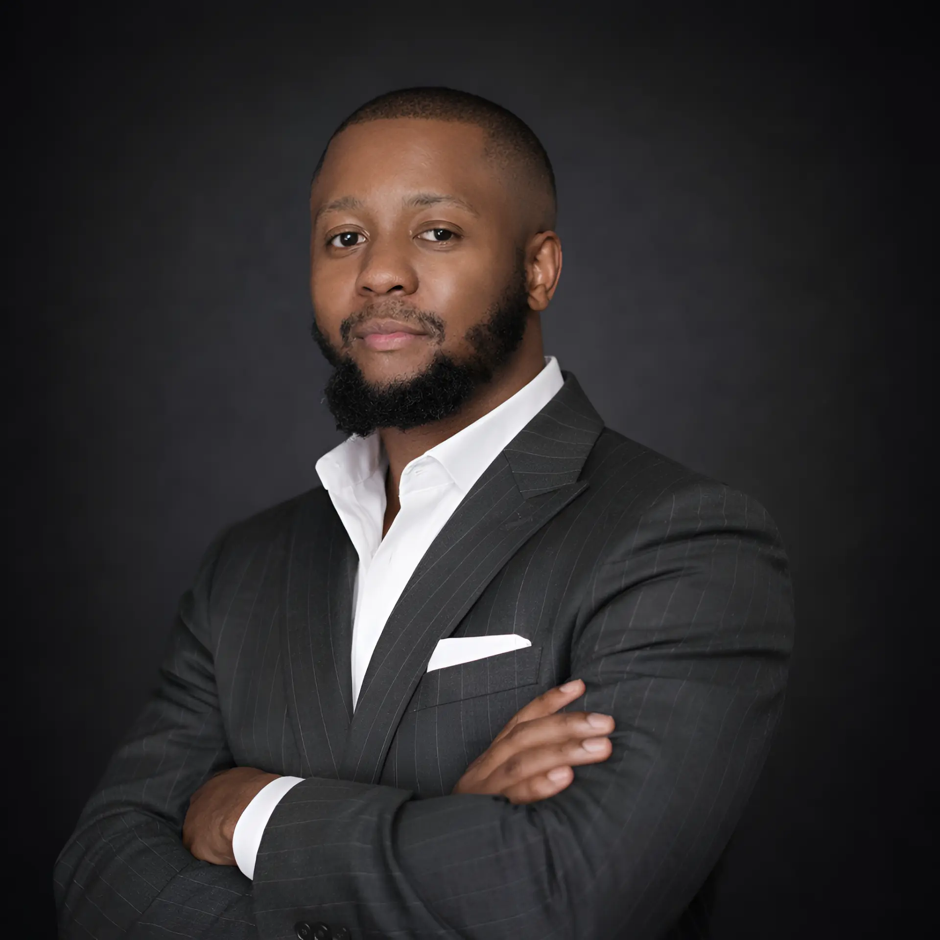 Studio portrait of Kabelo Ernest Nkomotje, founder of noeflo, in a pinstripe suit